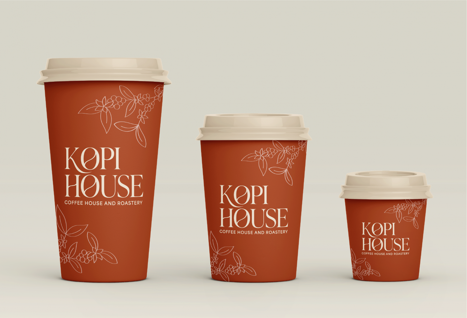 Three coffee cups that are in three different sizes that have the logo ‘Kopi House’ and the slogan ‘coffee house and roastery’ on the front of each cup.