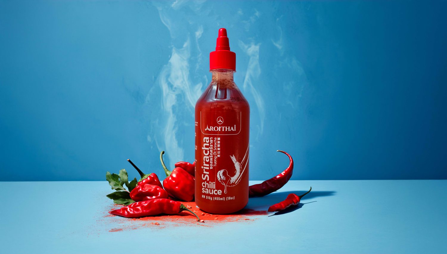 Aroi Thai, red bottle packaging with detailed, outline shrimp illustration